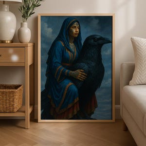 May include: A framed art print featuring a woman in a blue hooded robe with gold trim, adorned with tattoos, embracing a large black raven. The artwork has a vintage aesthetic with a cloudy blue sky background.