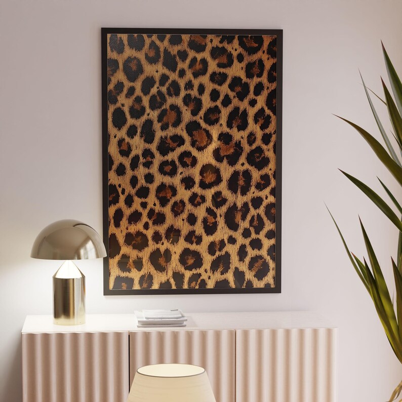 May include: A framed print of a leopard print pattern in shades of brown and black.
