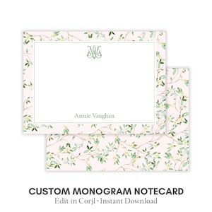 Può includere: Un biglietto con monogramma personalizzato con un design floreale. Il biglietto presenta uno sfondo rosa chiaro con un delicato motivo di foglie verdi e fiori bianchi. Il testo "Annie Vaughan" è stampato sulla carta.