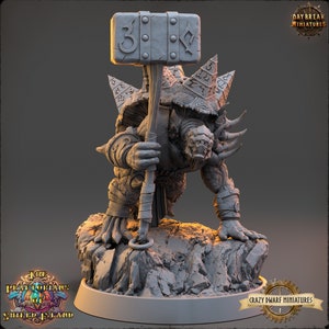 May include: A gray, detailed miniature of a turtle-like creature with a spiked shell, holding a large hammer with runes. The creature is standing on a rocky base. The miniature is part of the "The Priatokians of Shield Island" game.