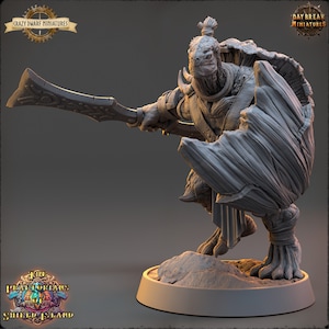 May include: A gray miniature figurine of a reptilian warrior, wielding a large sword and shield. The figure is in a dynamic pose, with intricate details on the armor and weapon. The base is a circular platform with a small mound of dirt. Logos for "Crazy Dwarf Miniatures" and "Daybreak Miniatures" are visible.