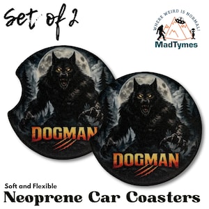 May include: Set of two black neoprene car coasters. Each coaster features a werewolf illustration with the word "DOGMAN" in orange and red. The background includes a full moon and a forest. The coasters are soft and flexible.