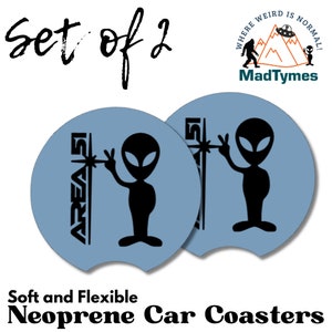 May include: Set of two blue neoprene car coasters with a black alien graphic and the text "AREA 51" on each coaster.