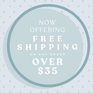 May include: A light blue circular graphic with a darker blue border and white polka dot background. The text reads: NOW OFFERING FREE SHIPPING ON ANY ORDER OVER $35. The design is centered and uses a clean, white serif font for the announcement.