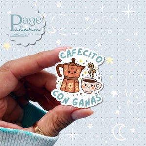 May include: A sticker featuring a brown coffee maker and a smiling coffee cup with the text "Cafecito con Ganas". The sticker has a light blue background with white stars and a logo in the upper left corner.