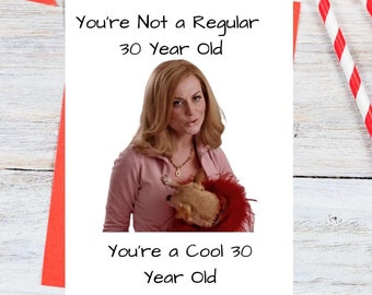 May include: A humorous greeting card with a photo of a woman holding a stuffed animal. The text on the card reads "You're Not a Regular 30 Year Old. You're a Cool 30 Year Old."