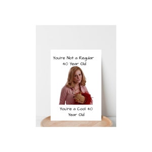 May include: A greeting card with a photo of a woman holding a small dog. The text on the card reads "You're Not a Regular 40 Year Old. You're a Cool 40 Year Old."