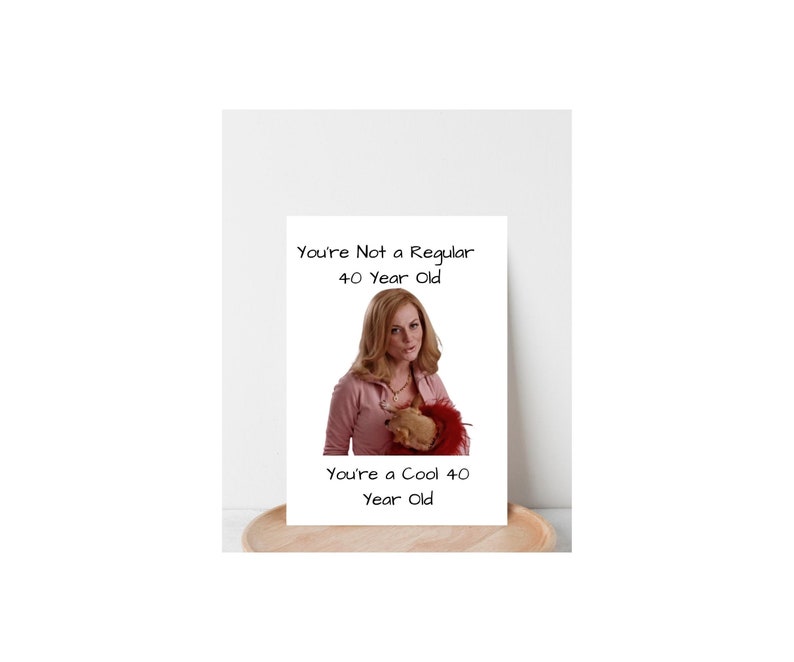 May include: A greeting card with a photo of a woman holding a small dog. The text on the card reads "You're Not a Regular 40 Year Old. You're a Cool 40 Year Old."