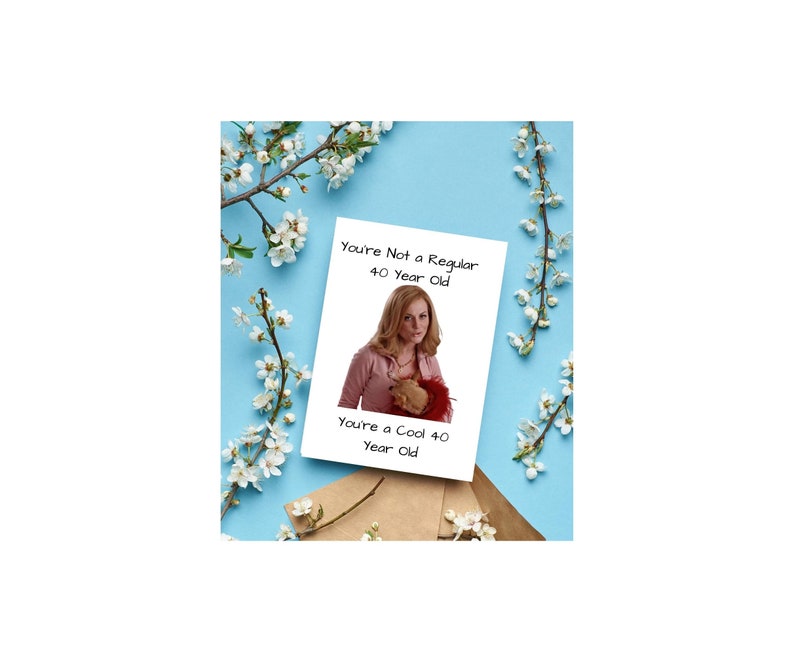 May include: A white card with a picture of a woman holding a stuffed animal. The card says "You're Not a Regular 40 Year Old. You're a Cool 40 Year Old."