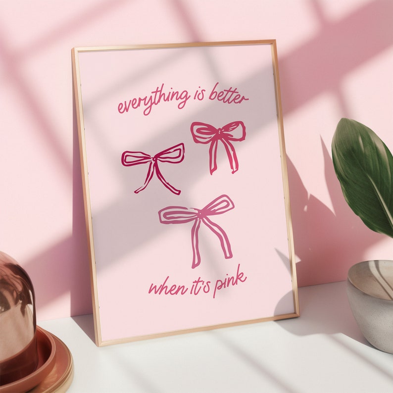 May include: A pink framed print with the text "everything is better when it's pink" and three pink bows.