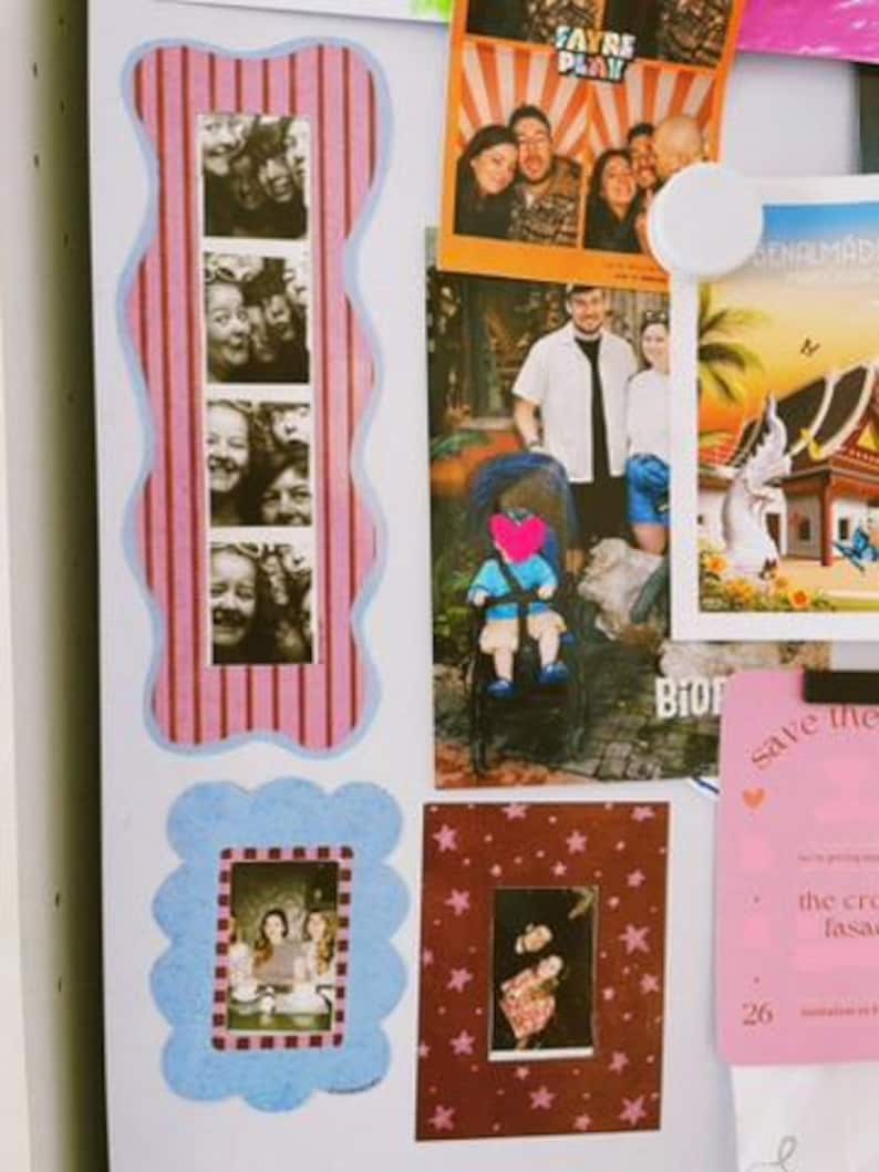 May include: A collection of photographs and cards displayed on a white surface. Items include a vertical photo strip with a pink striped border, a photo of people in a booth, a photo of a person in a stroller, and a pink card with text.