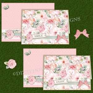 May include: Two pink floral cards with a white background and green leaves. The top card has the word "SMILE" on a green ribbon. The bottom card has the word "ENJOY" on a green ribbon.