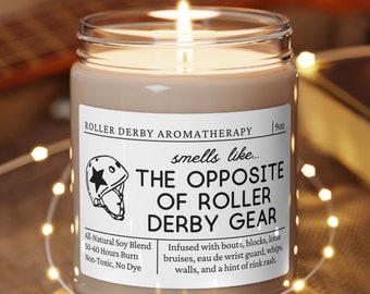 May include: A brown candle with a white label that reads "Roller Derby Aromatherapy" and "smells like... The Opposite of Roller Derby Gear". The label also includes the text "All Natural Soy Blend, 50-60 Hours Burn, Non-Toxic, No Dye" and "Infused with bouts, blocks, bruises, eau de wrist guard, whip walls, and a hint of rink rash."