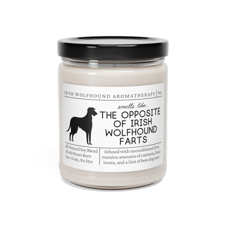 May include: A scented candle in a glass jar with a black lid. The label says "IRISH WOLFHOUND AROMATHERAPY" and "smells like... THE OPPOSITE OF IRISH WOLFHOUND FARTS." The candle is 255 grams and made with all-natural soy blend.
