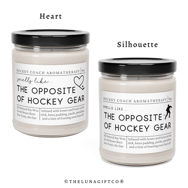 May include: Two glass candle jars with black lids. The jars are filled with a light beige soy wax. The labels on the jars read "Hockey Coach Aromatherapy" and "Smells Like... The Opposite of Hockey Gear". One jar has a heart icon and the other has a hockey player silhouette.