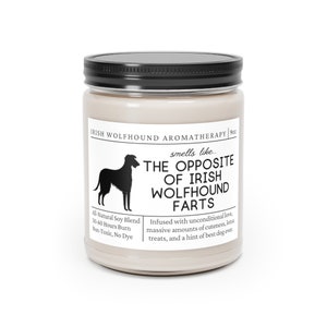 May include: A candle in a glass jar with a black lid. The label features an Irish Wolfhound silhouette and the text "The Opposite of Irish Wolfhound Farts." The candle is an all-natural soy blend and burns for 50-60 hours.