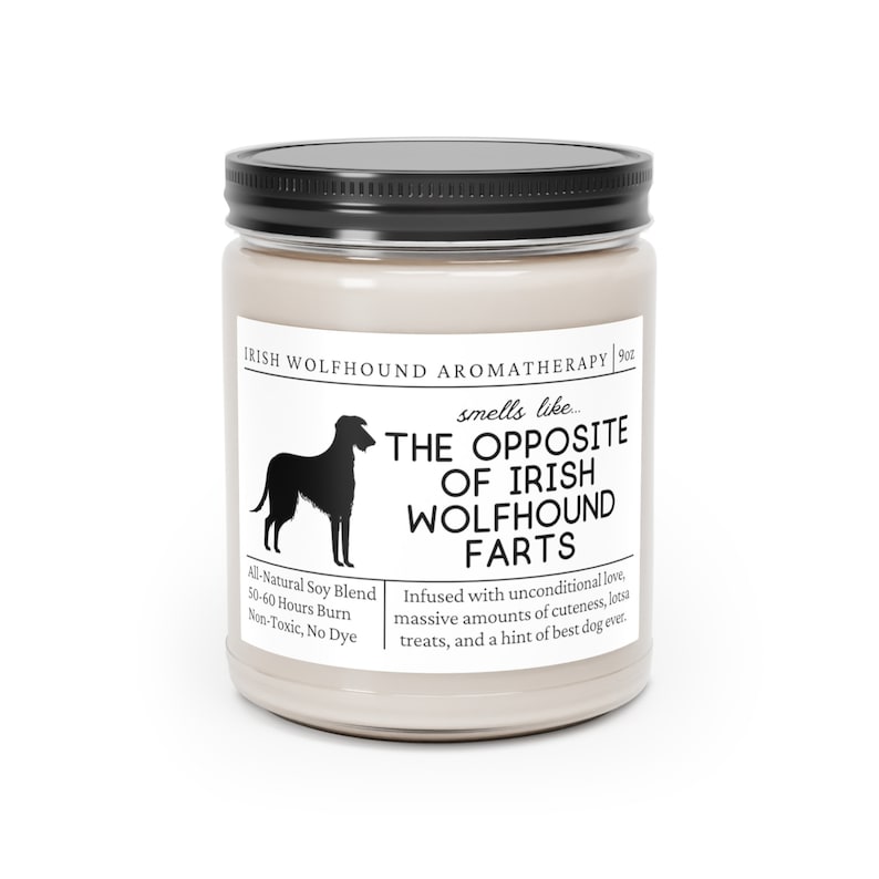 May include: A candle in a glass jar with a black lid. The label features an Irish Wolfhound silhouette and the text "The Opposite of Irish Wolfhound Farts." The candle is an all-natural soy blend and burns for 50-60 hours.