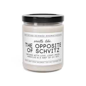 May include: A white candle jar with a black lid. The label reads "SATISFIED SCHNOZ AROMATHERAPY" and "smells like... THE OPPOSITE OF SCHVITZ" with the text "INFUSED WITH LOVE, LIGHT, MAZEL. MIRACLES & A HINT OF OY VEY!" and "100% SOY WAX BLEND | 50-60 HOURS | 9oz".