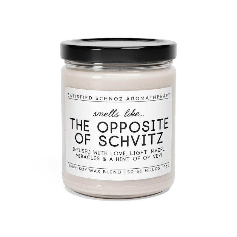 May include: A white candle jar with a black lid. The label reads "SATISFIED SCHNOZ AROMATHERAPY" and "smells like... THE OPPOSITE OF SCHVITZ" with the text "INFUSED WITH LOVE, LIGHT, MAZEL. MIRACLES & A HINT OF OY VEY!" and "100% SOY WAX BLEND | 50-60 HOURS | 9oz".