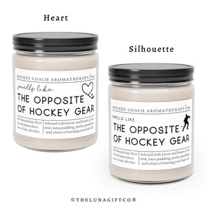 May include: Two 9oz soy wax candles with black lids and labels that read "Hockey Coach Aromatherapy" and "Smells Like... The Opposite of Hockey Gear". One candle has a heart icon and the other has a hockey player silhouette.