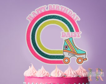 May include: A pink and green glitter rainbow cake topper with the text "Happy Birthday Daisy" and a blue and pink roller skate.