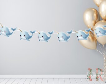 Decoração de festa de aniversário com faixa de narval e bandeirinhas