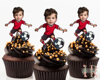 May include: Three chocolate cupcakes with black frosting and gold sprinkles. Each cupcake has a topper of a cartoon boy wearing a red soccer jersey and black shorts, kicking a soccer ball.