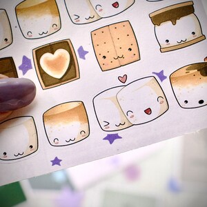 Closeup of sticker sheet with cute  marshmallows and gram crackers and chocolate bars.