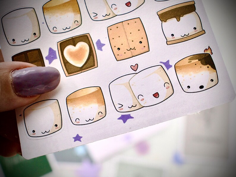 Closeup of sticker sheet with cute  marshmallows and gram crackers and chocolate bars.