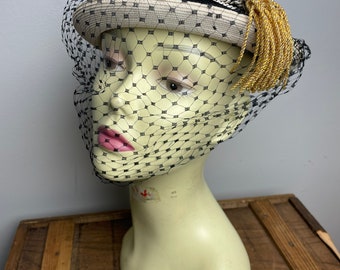 Vintage 1950s Black white pillbox toque hat with netting veil and gold tassel detail