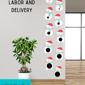 May include: A printable chart with nine snowman illustrations, each with a different size black circle for the middle. The snowman illustrations are white with red hats, black eyes, and a blue scarf. The chart is labeled "Labor and Delivery" and each snowman has a measurement in centimeters.