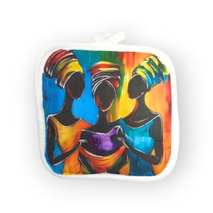 May include: Square white pot holder featuring an abstract painting of three figures with dark skin, wearing colorful head wraps and dresses. The background is a vibrant blend of blue, yellow, orange, and red.