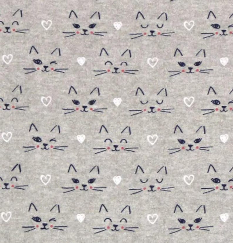 May include: A light gray fabric featuring a repeating pattern of dark gray cat faces and small white hearts. The cat faces display various expressions, including winking, smiling, and closed eyes, all rendered in a simple, hand-drawn line style.