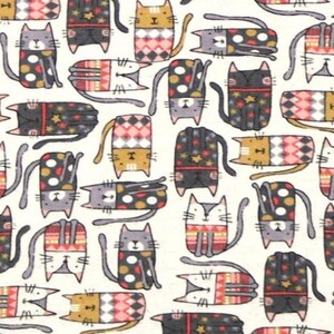 May include: A fabric pattern featuring a repeating print of stylized cats in various orientations. The cats are decorated with colorful geometric shapes, polka dots, and star motifs in shades of gray, black, orange, red, and white on a cream background.