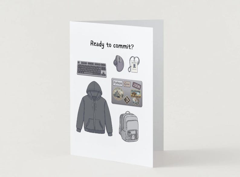 Peut inclure: Une carte de v&oelig;ux blanche avec le texte Ready to commit ? et des illustrations d'un sweat &agrave; capuche gris fonc&eacute;, un clavier noir, une souris d'ordinateur grise, un cordon, un ordinateur portable avec des autocollants et un sac &agrave; dos gris.