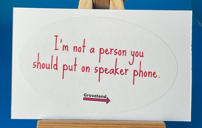 May include: White sticker with a red oval containing the text "I'm not a person you should put on speaker phone."  Below the oval is a red arrow with the word "Groveland" written above it.