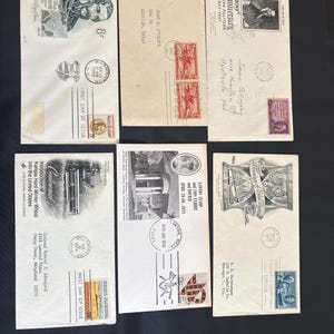 May include: Six vintage first day of issue envelopes arranged in two rows. Each envelope features unique commemorative postage stamps, postmarks, and printed historical illustrations or text, including references to Lajos Kossuth and Joseph Pulitzer.