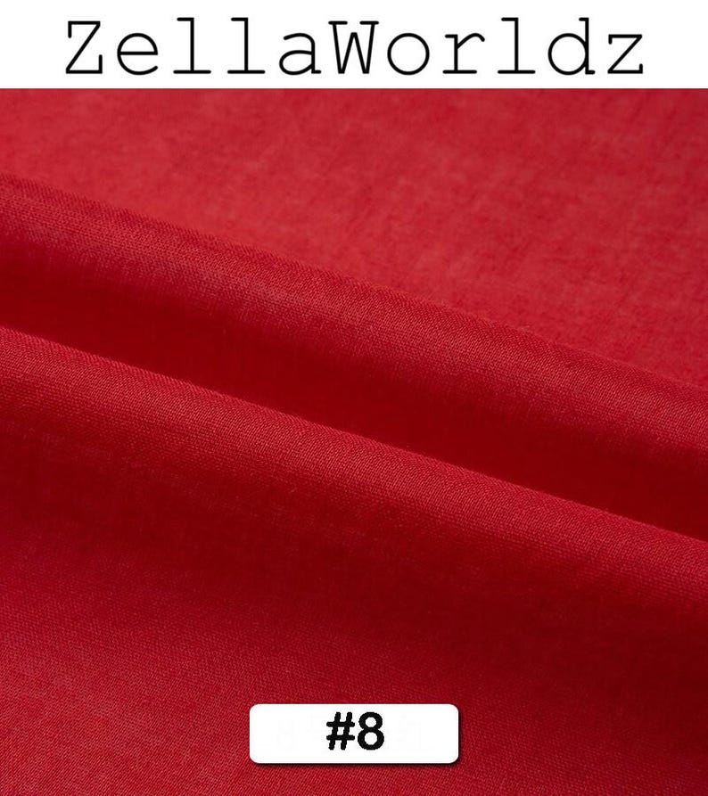 Peut inclure: Gros plan sur un tissu rouge vif avec des plis subtils. L'image pr&eacute;sente le texte "ZellaWorldz" en haut et un rectangle blanc avec le num&eacute;ro "#8" en bas. La texture du tissu est visible, sugg&eacute;rant un mat&eacute;riau doux.