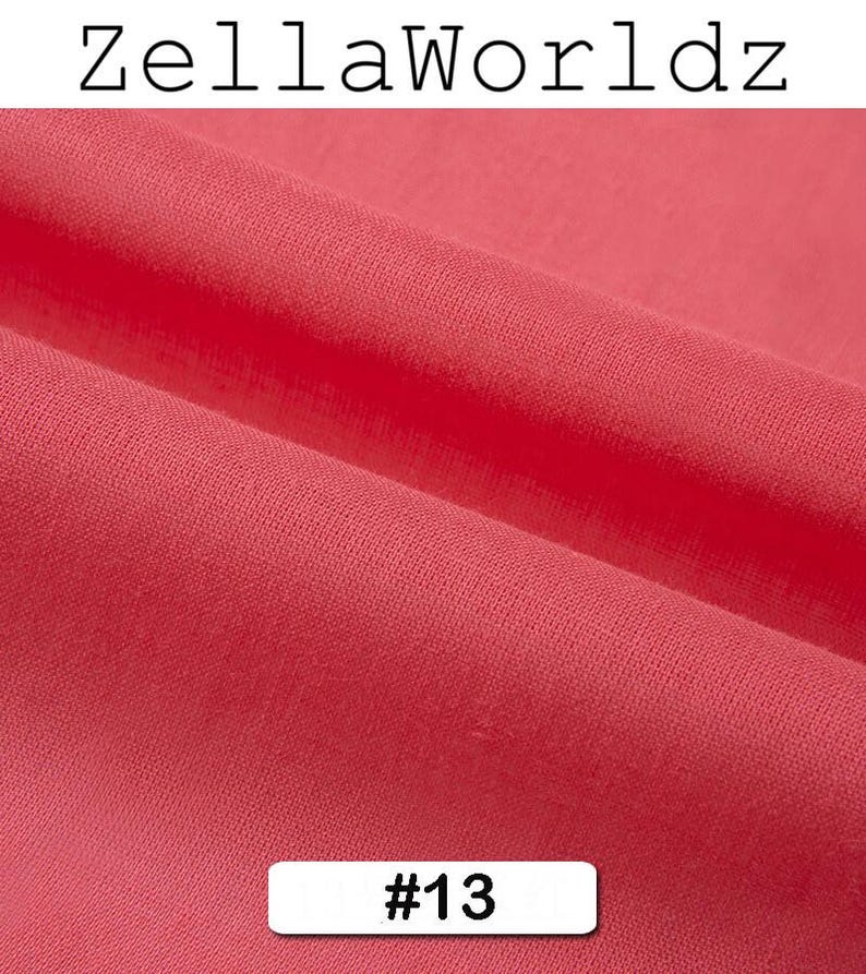 Peut inclure: Gros plan sur un morceau de tissu pli&eacute; de couleur corail. Le tissu a une texture douce et est l&eacute;g&egrave;rement froiss&eacute;. Le texte "ZellaWorldz" est en haut et le num&eacute;ro "#13" dans un rectangle blanc en bas.