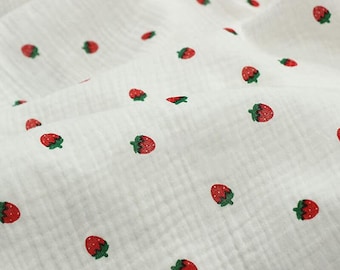 May include: White fabric with a repeating pattern of red strawberries with green stems. The fabric has a textured, crinkled appearance. The text "ZellaWorldz" is printed at the top of the image.