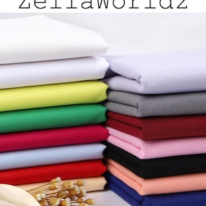 May include: Stacks of colorful fabric in various shades, including white, yellow, green, pink, and blue. The text "ZellaWorldz" is displayed at the top. A bundle of dried flowers is in the foreground.
