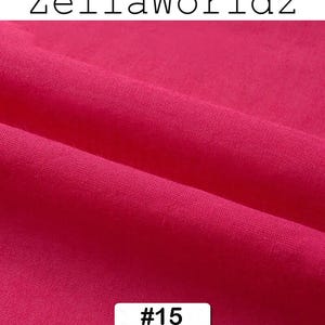 Peut inclure: Gros plan sur un tissu fuchsia vif, r&eacute;v&eacute;lant sa texture et ses plis. Le texte "ZellaWorldz" est en haut, et un rectangle blanc avec le num&eacute;ro "#15" est en bas. Le tissu est de couleur unie.