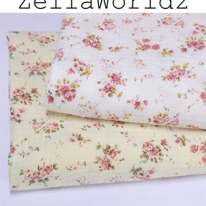 May include: Two floral fabric pieces. One is cream with pink roses and green leaves, the other pale yellow with the same pattern. The text "ZellaWorldz" is at the top. The fabric is likely cotton.