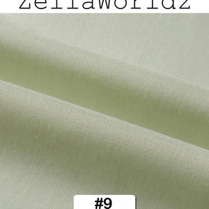 Peut inclure: Gros plan sur un tissu vert clair avec une texture et des plis visibles. Le texte "ZellaWorldz" est en haut, et un rectangle blanc avec le num&eacute;ro "#9" est en bas. Le tissu semble &ecirc;tre une mati&egrave;re douce.