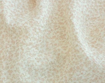May include: Close-up of fabric with a delicate floral pattern in soft pink and cream. The fabric is slightly wrinkled, suggesting it's a textile. The text "ZellaWorldz" is displayed at the top.