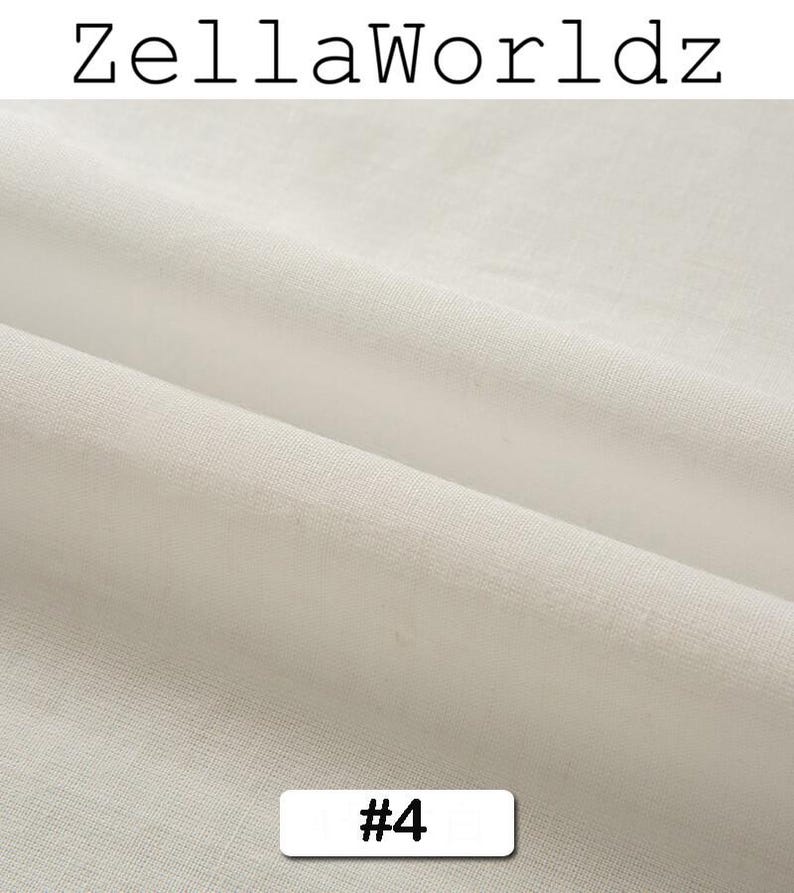 Peut inclure: Gros plan sur un tissu blanc cass&eacute; avec une texture et des plis visibles. Le texte "ZellaWorldz" est en haut et un rectangle blanc avec le num&eacute;ro "#4" est en bas.
