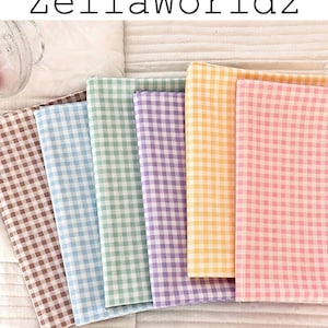 May include: A collection of folded fabric in various pastel colors, including brown, blue, green, purple, yellow, and pink. Each fabric features a classic gingham pattern. The text "ZellaWorldz" is displayed at the top.