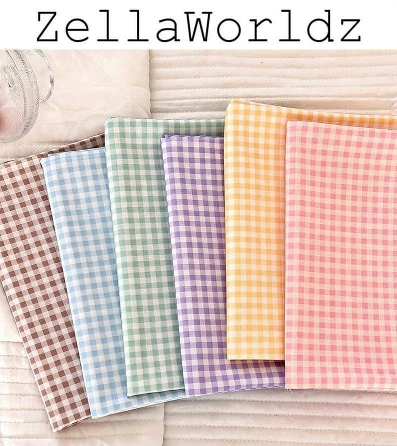 May include: A collection of folded fabric in various pastel colors, including brown, blue, green, purple, yellow, and pink. Each fabric features a classic gingham pattern. The text "ZellaWorldz" is displayed at the top.