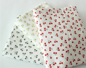 May include: Three fabric squares with a white background and a repeating pattern of red cherries with green stems and leaves. The fabric squares are stacked on top of each other, with the top square being white with red cherries, the middle square being yellow with gold cherries, and the bottom square being white with gray cherries.