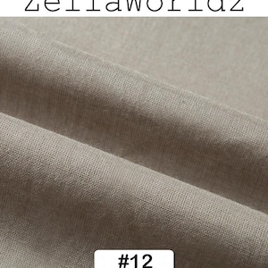Peut inclure: Gros plan sur une section de tissu beige neutre. Le tissu a un aspect textur&eacute; avec des d&eacute;tails de tissage visibles. Le texte "ZellaWorldz" est en haut et le num&eacute;ro "#12" est dans un rectangle blanc en bas.